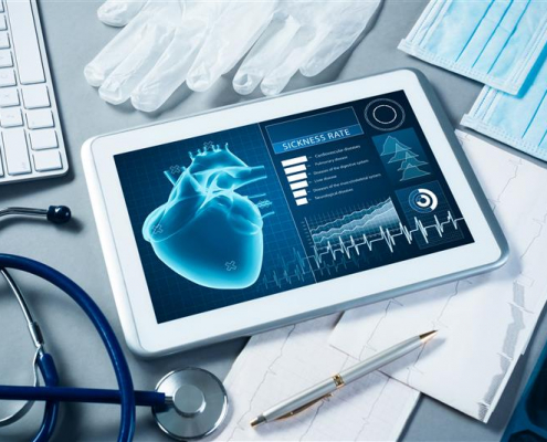 Tablet on messy desk with a virtual heart with vitals on the screen